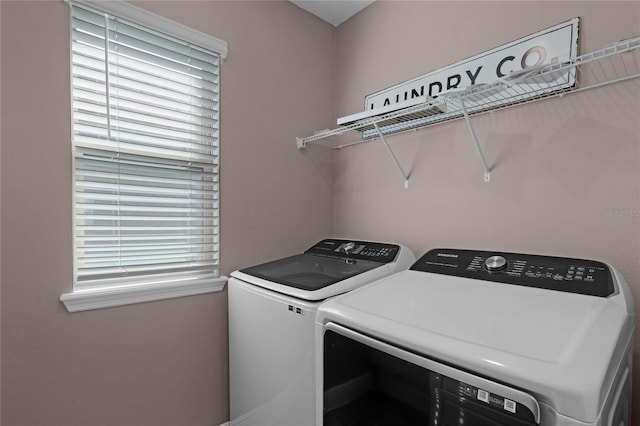 laundry area featuring a wealth of natural light and washing machine and dryer