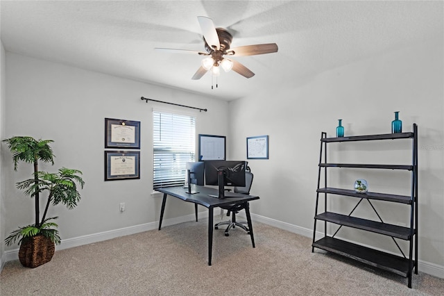 office featuring a textured ceiling, light colored carpet, and ceiling fan