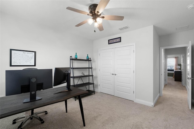 office space featuring light colored carpet and ceiling fan