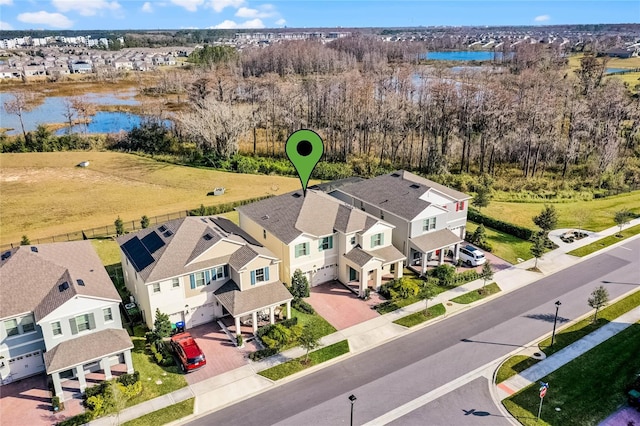 birds eye view of property with a water view