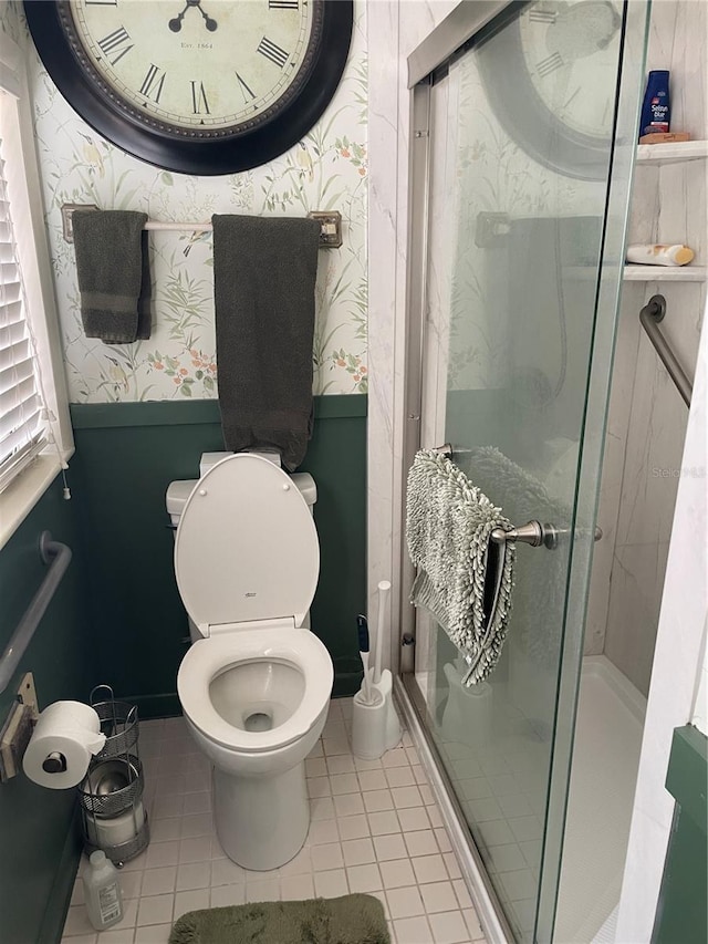 bathroom featuring an enclosed shower, tile patterned flooring, and toilet