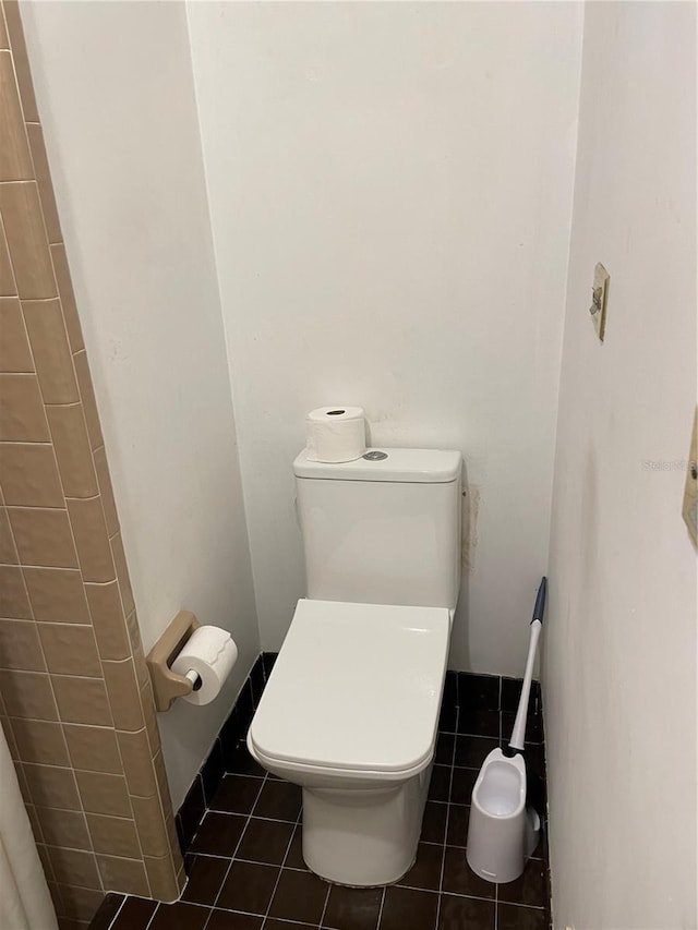 bathroom with toilet and tile patterned floors