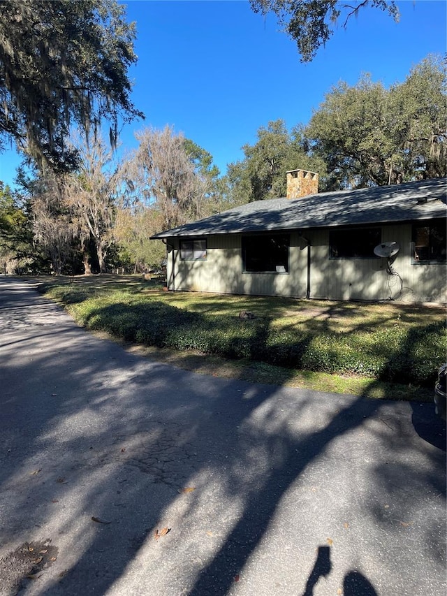 view of side of home featuring a lawn