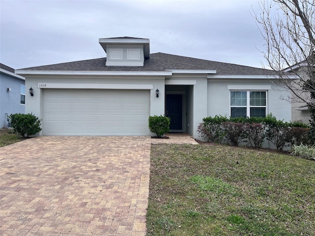 view of front of home with a front lawn and a garage