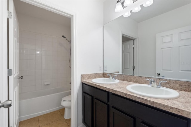 full bathroom with toilet, vanity, tile patterned flooring, and tiled shower / bath combo