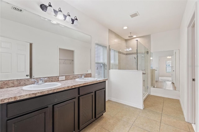 bathroom with vanity, tile patterned floors, and walk in shower