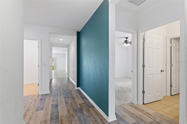 hallway with light wood-type flooring