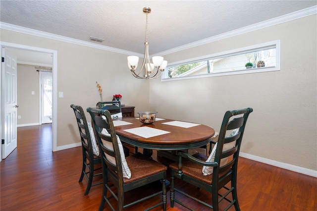 dining space with ornamental molding, dark hardwood / wood-style floors, a textured ceiling, and a notable chandelier