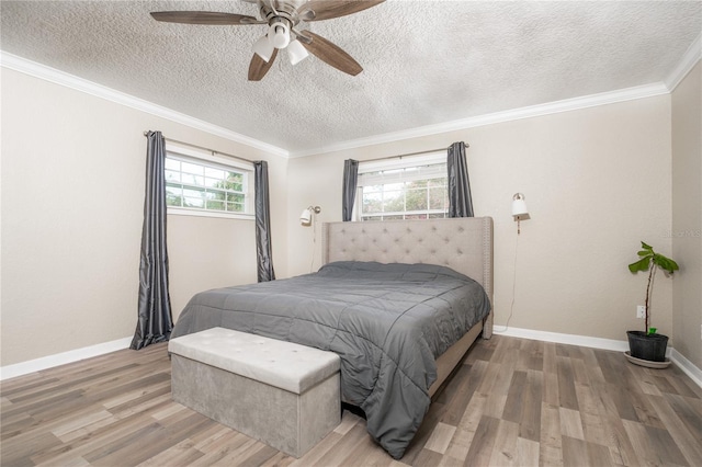 bedroom with multiple windows, a textured ceiling, wood-type flooring, and ceiling fan