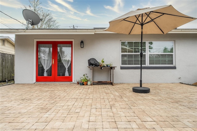 entrance to property featuring a patio area and french doors