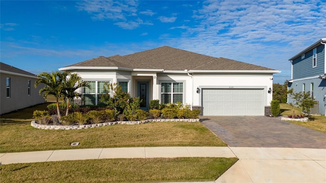 view of front of house featuring a garage and a front lawn