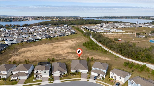 birds eye view of property featuring a water view and a residential view