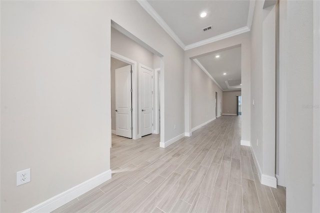 hall with baseboards, visible vents, ornamental molding, light wood-type flooring, and recessed lighting