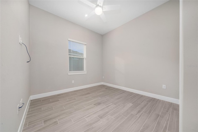 unfurnished room with ceiling fan, wood finish floors, and baseboards