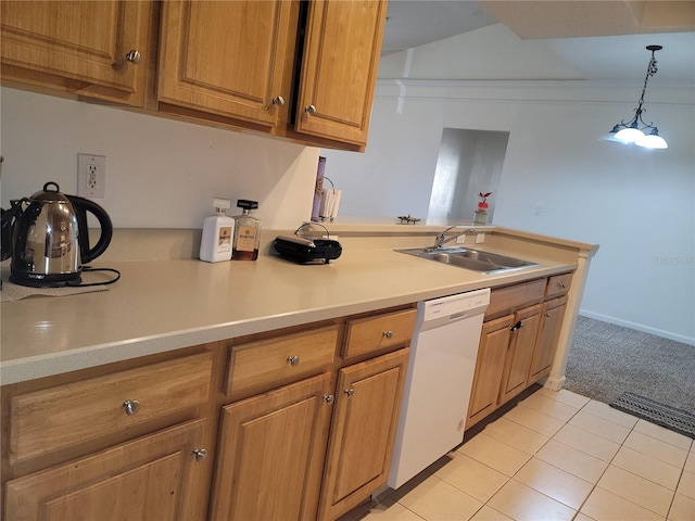 kitchen featuring a sink, a peninsula, brown cabinetry, and white dishwasher