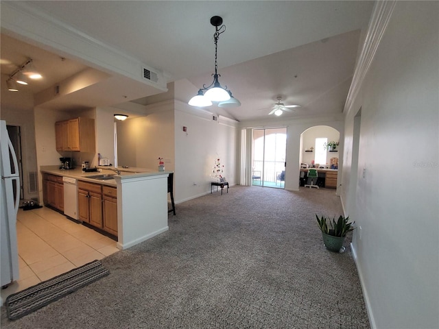 12216 Wild Iris Way Unit 112, Orlando, FL 32837 - kitchen with light countertops, light carpet, open floor plan, white appliances, and arched walkways
