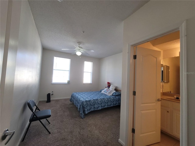 12216 Wild Iris Way Unit 112, Orlando, FL 32837 - bedroom featuring light colored carpet, baseboards, a textured ceiling, a sink, and ceiling fan