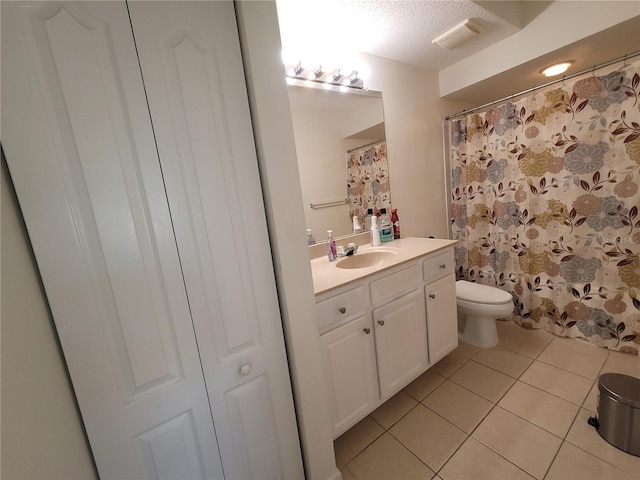 12216 Wild Iris Way Unit 112, Orlando, FL 32837 - full bathroom featuring a textured ceiling, toilet, tile patterned floors, and vanity