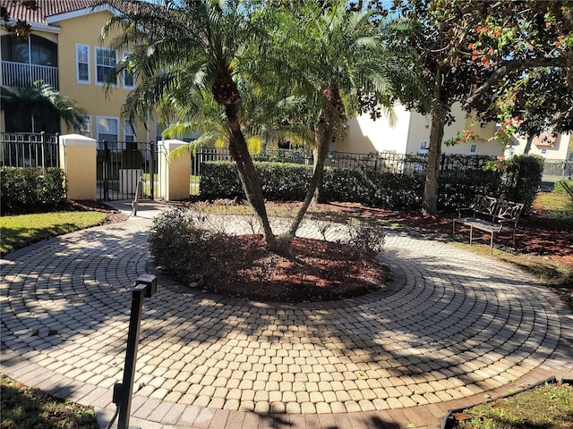 12216 Wild Iris Way Unit 112, Orlando, FL 32837 - view of home's community with a gate and a fenced front yard