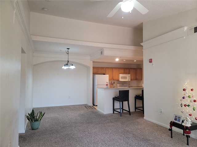 12216 Wild Iris Way Unit 112, Orlando, FL 32837 - kitchen with a kitchen bar, light colored carpet, white appliances, visible vents, and a ceiling fan