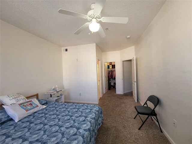 12216 Wild Iris Way Unit 112, Orlando, FL 32837 - carpeted bedroom featuring baseboards, a textured ceiling, visible vents, and a ceiling fan