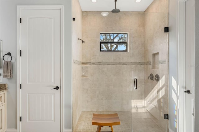 bathroom featuring vanity and a shower with shower door