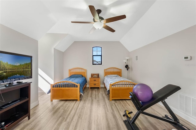 bedroom featuring ceiling fan, lofted ceiling, and light hardwood / wood-style floors