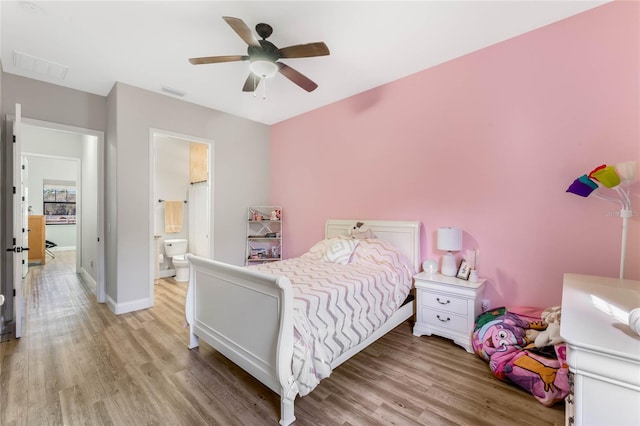 bedroom with ensuite bathroom, ceiling fan, and light hardwood / wood-style floors