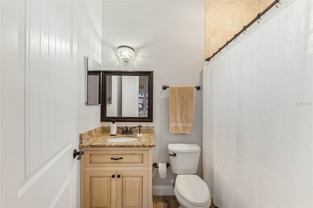 bathroom featuring hardwood / wood-style flooring, vanity, toilet, and a shower with shower curtain