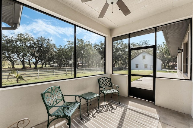 sunroom / solarium featuring ceiling fan