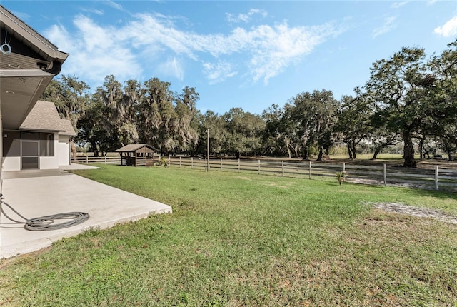 view of yard featuring a rural view and a patio area