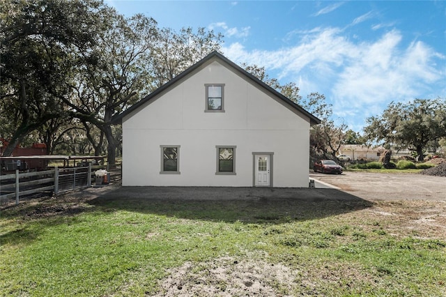 view of side of home featuring a yard