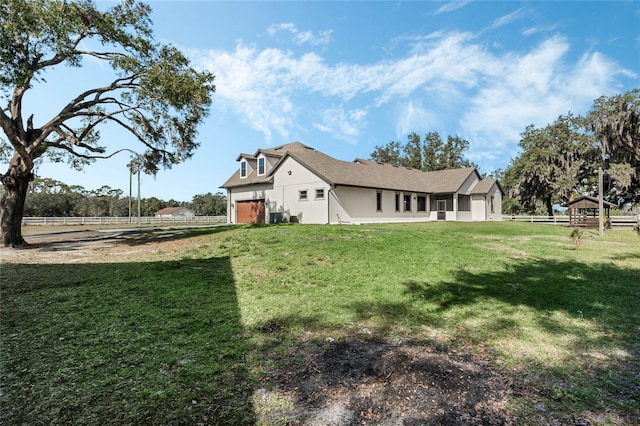 view of yard with a garage and cooling unit