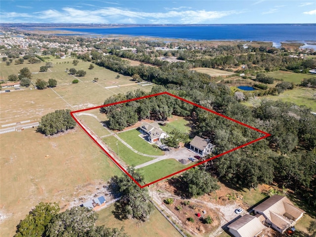 birds eye view of property with a water view