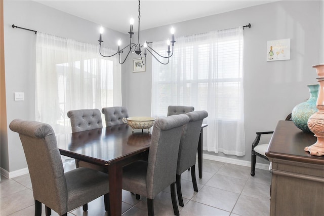 dining area with light tile patterned floors and a notable chandelier