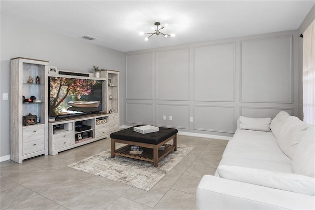 living room with an inviting chandelier and light tile patterned flooring