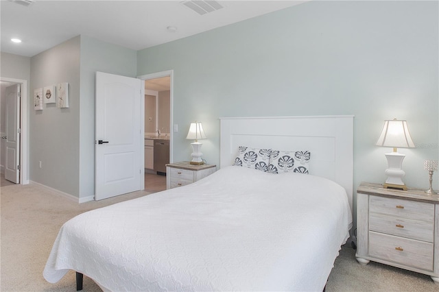 bedroom featuring light carpet, sink, and connected bathroom