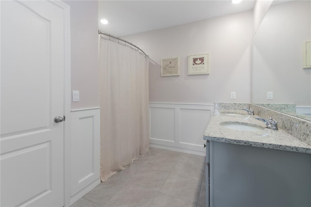 bathroom with tile patterned flooring and vanity