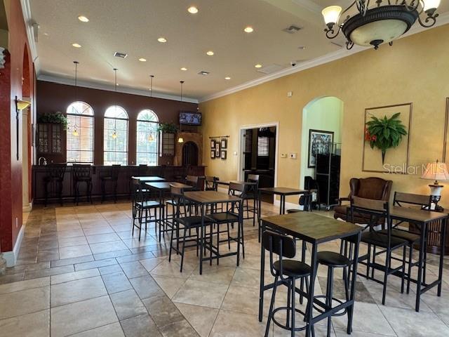 tiled dining space with crown molding