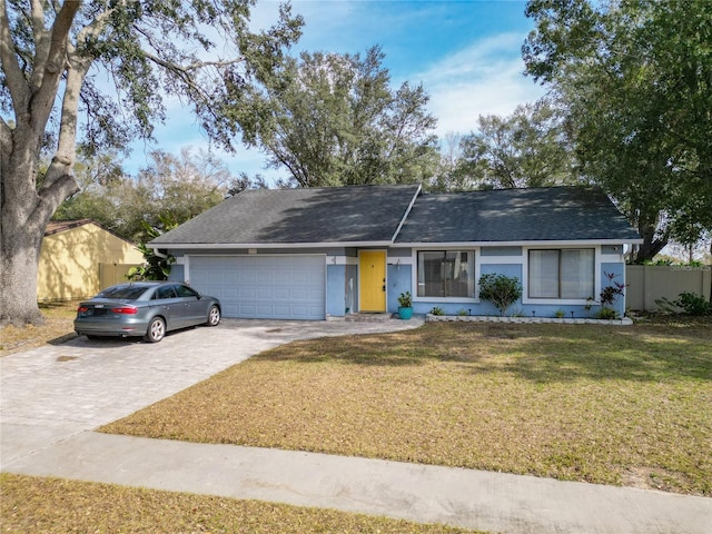 ranch-style house featuring a garage and a front yard