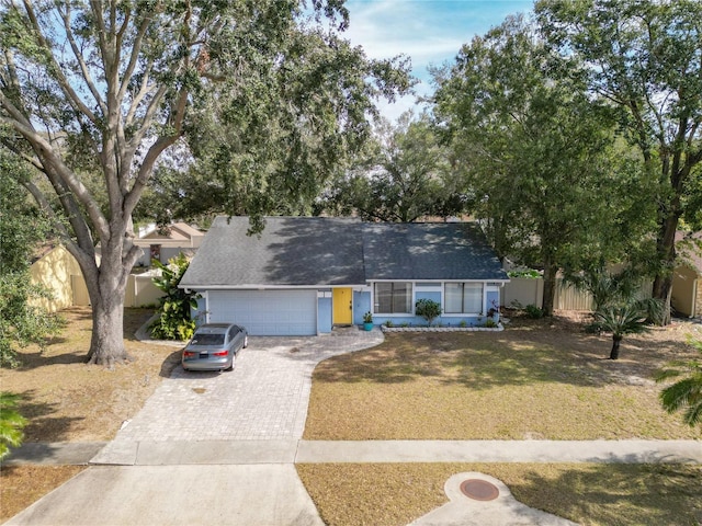 view of front of home featuring a garage and a front lawn