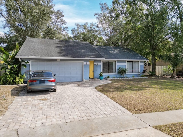 single story home with a garage and a front yard