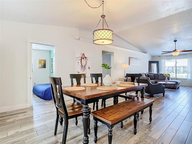 dining space with vaulted ceiling and ceiling fan