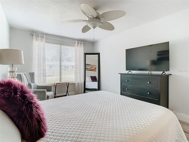 bedroom with a textured ceiling and ceiling fan