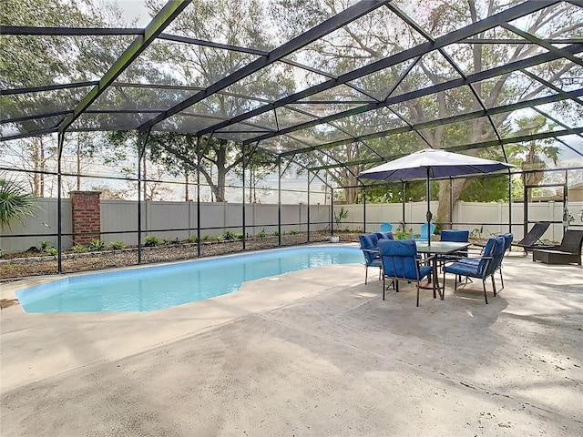 view of pool featuring a patio and glass enclosure