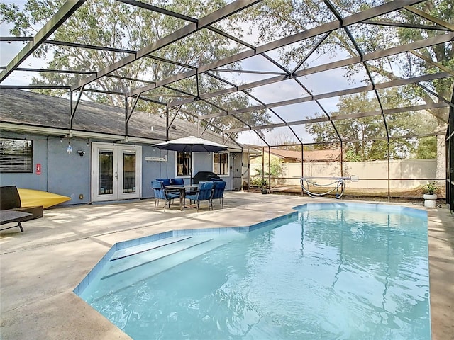 view of swimming pool featuring a patio area, french doors, and glass enclosure