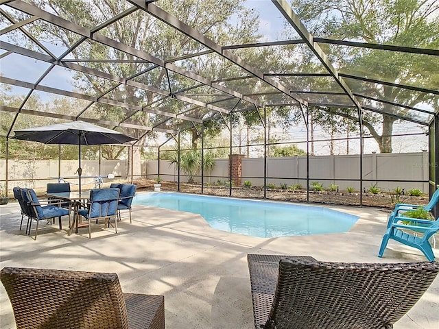 view of swimming pool featuring a patio area and glass enclosure