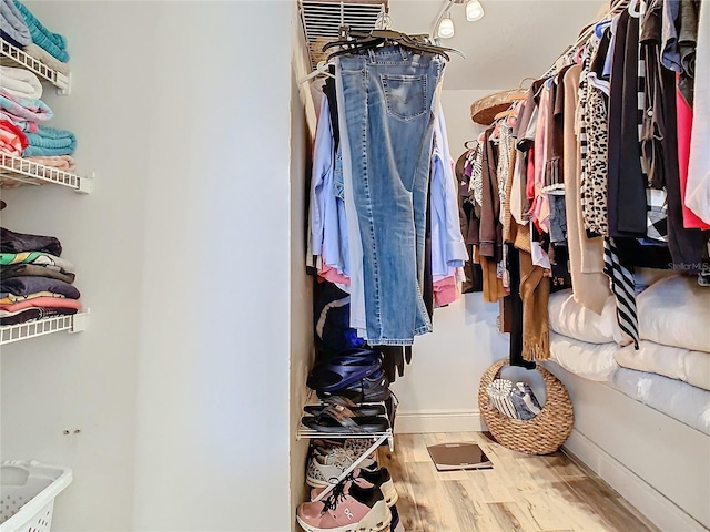 spacious closet featuring hardwood / wood-style flooring