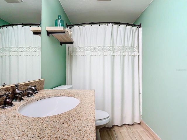 bathroom featuring vanity, hardwood / wood-style flooring, and toilet