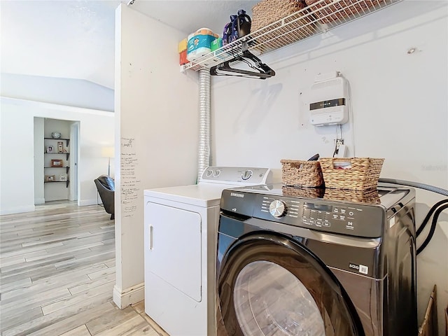 washroom with light hardwood / wood-style floors and independent washer and dryer